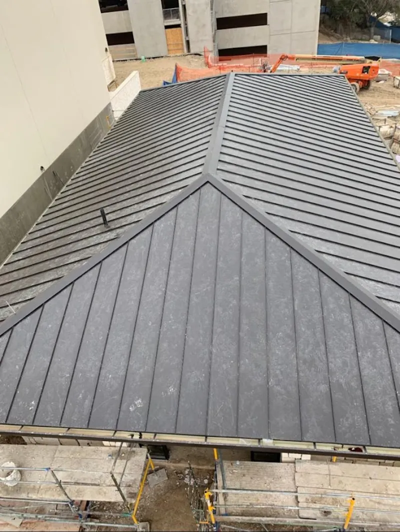 Commercial metal roof construction with crane equipment in Silver Spring